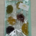 Gift-style package of assorted round cookies in a clear bag with a turquoise backing, a pale blue ribbon, and a Rokumeikan Tokyo label.