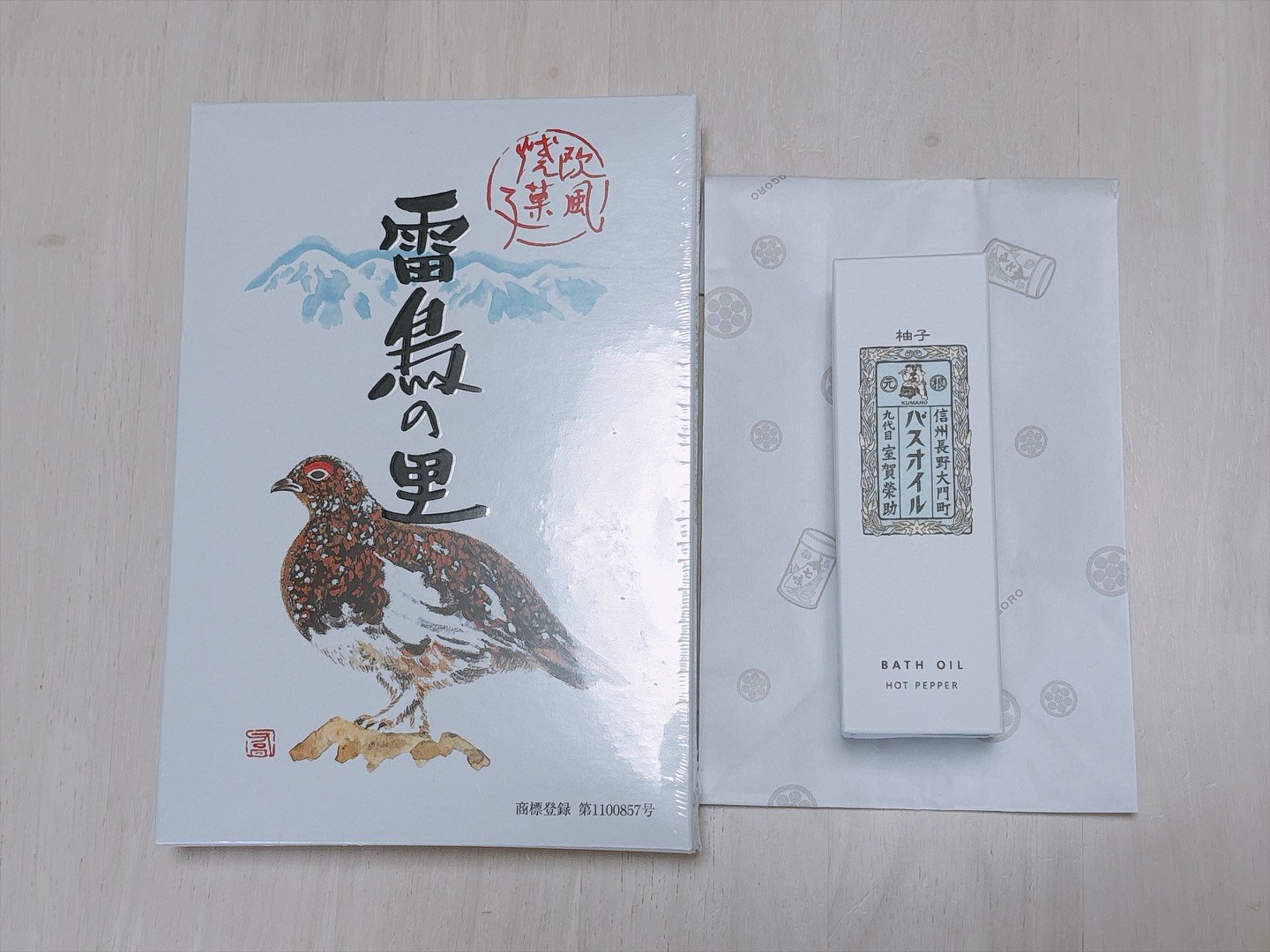 Light blue book with a brown-and-black chicken illustration and bold black Japanese characters on the cover, placed on a light wooden surface.